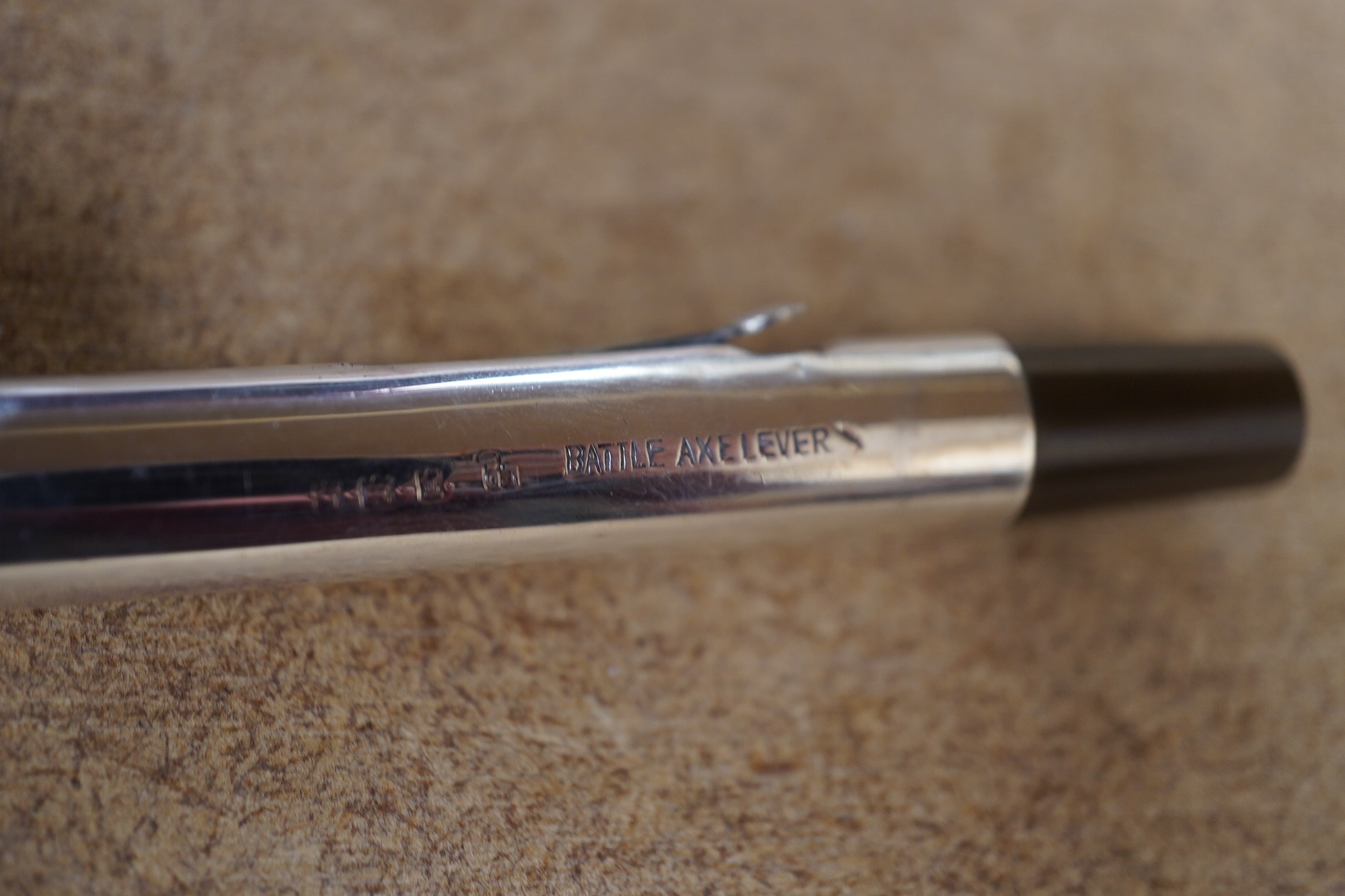 A Battle Axe lever fountain pen in silver, with 14ct gold nib, 14cm in length. Condition - fair